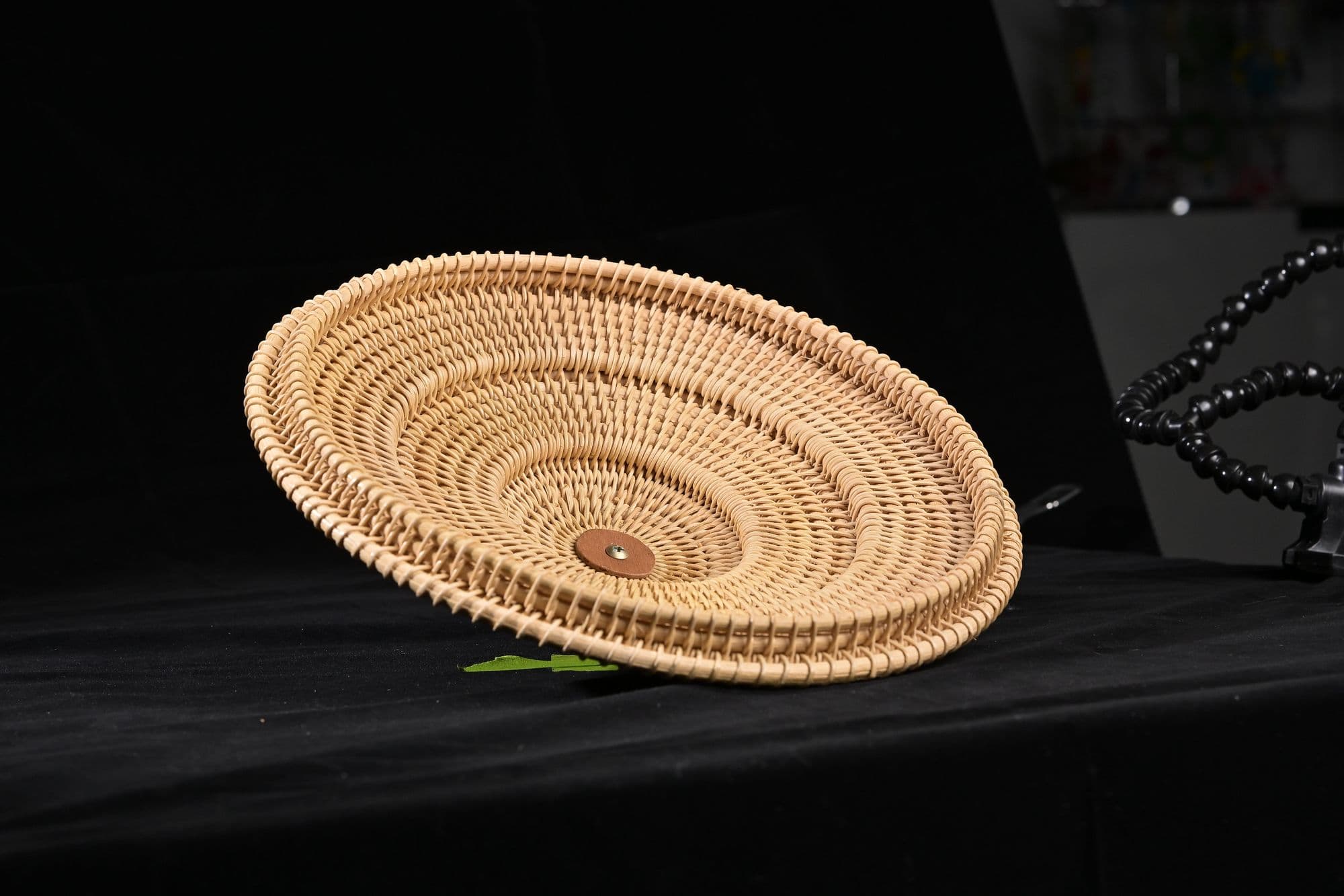 Woven basket bowl photographed on black for a product catalog
